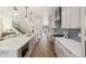 Spacious kitchen with large island, stainless steel appliances, grey cabinets, and hardwood floors at 2010 Irving St, Denver, CO 80211