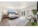 Bright main bedroom with a king bed and patio access, bathed in natural light at 2010 Irving St, Denver, CO 80211