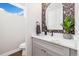 Chic powder room with floral wallpaper, quartz countertop, and contemporary fixtures for an elegant touch at 2010 Irving St, Denver, CO 80211