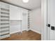 Bright walk-in closet features custom shelving, hanging rods, and wood flooring at 2010 Irving St, Denver, CO 80211