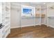 Bright walk-in closet featuring built-in shelves and hardwood floors at 2010 Irving St, Denver, CO 80211