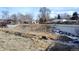 Creek running through a grassy field with houses in the background at 3710 Miller Ct, Wheat Ridge, CO 80033