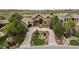 Aerial view of an estate showing the meticulously landscaped grounds, circular driveway, and mature trees at 5886 Amber Ridge Dr, Castle Pines, CO 80108