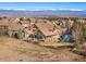 Aerial view of a home with a backyard, patio, playground, and stunning mountain views at 5886 Amber Ridge Dr, Castle Pines, CO 80108