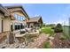Beautiful outdoor living space with a fire pit, patio, and manicured lawn and gardens at 5886 Amber Ridge Dr, Castle Pines, CO 80108