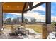 Covered backyard patio with dining area, perfect for outdoor entertaining at 5886 Amber Ridge Dr, Castle Pines, CO 80108