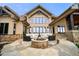 Beautiful patio area with stone fireplace and comfortable seating, perfect for outdoor relaxation and entertaining at 5886 Amber Ridge Dr, Castle Pines, CO 80108