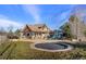 Spacious backyard featuring a trampoline and playset, perfect for Gathering fun at 5886 Amber Ridge Dr, Castle Pines, CO 80108