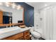 Bathroom with modern vanity, neutral color palette, bright lighting, and shower-tub combo at 5886 Amber Ridge Dr, Castle Pines, CO 80108