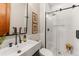 Clean bathroom with a modern sink, black accents, and a glass-enclosed shower at 5886 Amber Ridge Dr, Castle Pines, CO 80108