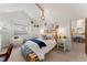 Cozy bedroom featuring a unique pallet bed frame, hammock chair, and plenty of natural light at 5886 Amber Ridge Dr, Castle Pines, CO 80108