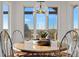 Breakfast nook with table and chairs positioned under a modern light fixture and large windows at 5886 Amber Ridge Dr, Castle Pines, CO 80108