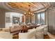 Elegant dining room featuring a rustic wood ceiling, modern chandelier, and comfortable, stylish seating at 5886 Amber Ridge Dr, Castle Pines, CO 80108