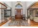 Entryway foyer features hardwood floors, a large wooden door, and high ceilings at 5886 Amber Ridge Dr, Castle Pines, CO 80108