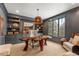 Stylish office with custom built-ins, a unique live edge desk, and ample natural light at 5886 Amber Ridge Dr, Castle Pines, CO 80108