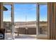 Expansive sliding glass doors open to stunning countryside views and outdoor seating at 5886 Amber Ridge Dr, Castle Pines, CO 80108