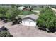 An aerial view of an outbuilding with a two-car garage surrounded by trees at 2091 Tate Ave, Fort Lupton, CO 80621