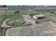 Aerial shot of a horse property with a round pen, loafing shed, and fencing at 2091 Tate Ave, Fort Lupton, CO 80621