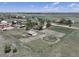 Drone shot of a rural property including a home, barn, horse pen, and fenced pastures at 2091 Tate Ave, Fort Lupton, CO 80621