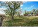 Spacious backyard with mature trees and a wooden fence, perfect for outdoor activities at 2091 Tate Ave, Fort Lupton, CO 80621