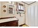 Cozy bathroom featuring wood accents, vanity storage, and tiled floors at 2091 Tate Ave, Fort Lupton, CO 80621