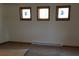 Cozy bedroom featuring natural lighting through its three windows at 2091 Tate Ave, Fort Lupton, CO 80621