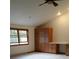 Bedroom featuring built-in wooden cabinets and a desk area, complemented by a window for natural light at 2091 Tate Ave, Fort Lupton, CO 80621