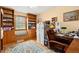Home office with built-in shelves, ample storage, and a comfortable workspace at 2091 Tate Ave, Fort Lupton, CO 80621