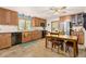 Bright kitchen featuring wood cabinetry, stainless steel appliances, and a dining table at 2091 Tate Ave, Fort Lupton, CO 80621