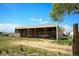 Open-air outbuilding provides ranch storage for tractor and other ranch equipment at 2091 Tate Ave, Fort Lupton, CO 80621