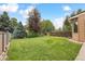 Lush backyard featuring a well-maintained lawn and mature trees, ideal for outdoor activities at 8588 E Costilla Ave, Centennial, CO 80112