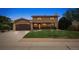 Charming two-story home with a well-manicured lawn and inviting curb appeal at dusk at 8588 E Costilla Ave, Centennial, CO 80112
