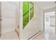 Hallway view with natural light, tile flooring and a staircase to upper level at 8588 E Costilla Ave, Centennial, CO 80112