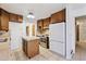 Functional kitchen with wooden cabinets, tiled floors, and a stainless steel range at 8588 E Costilla Ave, Centennial, CO 80112