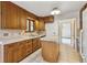 Functional kitchen featuring wood cabinets, tile countertops and an island workspace at 8588 E Costilla Ave, Centennial, CO 80112