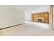 Spacious living room with brick fireplace, wood paneled wall and soft carpet at 8588 E Costilla Ave, Centennial, CO 80112