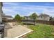 An outdoor view of a backyard with a trampoline, picnic table, and concrete patio at 1341 Kingfisher Ave, Brighton, CO 80601