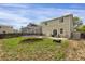 A spacious yard includes a trampoline, patio, seating, and slider to the home at 1341 Kingfisher Ave, Brighton, CO 80601