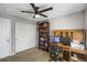 This room has a dark fan, bookcase, wood desk, and natural light at 1341 Kingfisher Ave, Brighton, CO 80601
