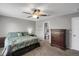 Bedroom boasts a ceiling fan, dresser, carpet, and ensuite bathroom at 1341 Kingfisher Ave, Brighton, CO 80601