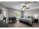 This bedroom features a ceiling fan, a window for natural light, and a desk area for work or study at 1341 Kingfisher Ave, Brighton, CO 80601