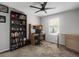 This room has a dark fan, bookcase, wood desk, and natural light at 1341 Kingfisher Ave, Brighton, CO 80601