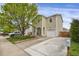 Charming two-story home with a well-manicured lawn and a mature shade tree at 1341 Kingfisher Ave, Brighton, CO 80601