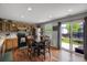 Eat-in kitchen with wood cabinets, stainless steel appliances, and backyard access at 1341 Kingfisher Ave, Brighton, CO 80601