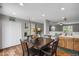Eat-in kitchen featuring laminate countertops, wood floors and white double-door pantry at 1341 Kingfisher Ave, Brighton, CO 80601