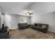 Spacious living room featuring neutral walls, cozy carpet, and a contemporary ceiling fan at 1341 Kingfisher Ave, Brighton, CO 80601