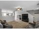 Bright living room with a ceiling fan, neutral walls, and seamless transition to other living spaces at 1341 Kingfisher Ave, Brighton, CO 80601