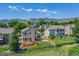 Wide aerial shot showing the property and neighboring homes with mountain views and community landscape at 14191 W Amherst Ave, Lakewood, CO 80228