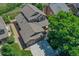 Aerial view of the home highlighting the landscaped yard, driveway, and roof at 14191 W Amherst Ave, Lakewood, CO 80228