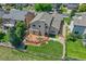 Overhead perspective of the property, showcasing the backyard deck, putting green, and manicured lawn at 14191 W Amherst Ave, Lakewood, CO 80228
